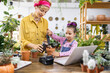 © sofiko14 - A woman and a young girl are potting plants, learning about gardening and enjoying quality time together