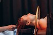 © Roman - Woman enjoying hydrotherapy hair treatment in spa salon. Japanese spa head