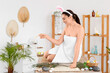 © Pixel-Shot - Young woman with bunny ears and Easter eggs sitting in spa salon