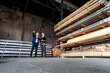 © Westend61 - Two businessmen with folder talking in an old storehouse