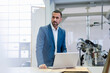 © Westend61 - Businessman using laptop in a factory