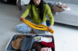 © Charlie's - Woman packing suitcase on bed for a new journey packing list for travel planning, preparing vacation Book Now Traveling Transportation