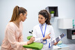© Graphicroyalty - Medical consultation and ultrasound results. Female doctor explaining test report to patient, Healthcare and Medicine concept. Professional physician holding clipboard and talking to young woman.