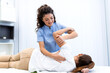 © Graphicroyalty - Physical therapy and rehabilitation. Physiotherapist stretching patient's arm, Healthcare and Medicine concept. Professional therapist helping woman with shoulder injury at medical clinic.