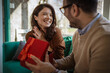 © Miljan Živković - Couple celebrating anniversary with surprise gift giving moment