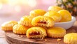© latifah - Delicious pineapple jam filled cookies on a wooden board with a bowl of cookies in the background
