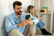 © NDABCREATIVITY - Gadget addiction and relationship problems. Couple with smartphones ignoring each other