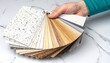 © Robert - Hand holding fan deck of countertop material samples