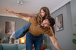 © Dexon Dee - Father and daughter playing piggyback ride at home