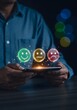 © Abu - Man holding smartphone with smiley faces emoticons person