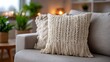 © SashaMagic - Cozy knitted cushion on modern sofa in stylish living room