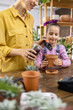 © sofiko14 - A young girl learns about gardening with her mother, enjoying a fun activity together