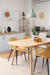 © Pixel-Shot - Interior of stylish kitchen with dining table, chairs and lamp