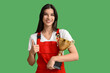 © Pixel-Shot - Female worker with gold cup showing thumb-up on green background
