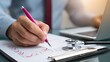 © Opaopi - Medical professional completing checklist using pen and laptop healthcare concept