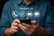 © Sultana - Businessman using smartphone with contact us icon or customer support hotline people connect for contact us concept.