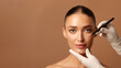 © Home-stock - Beautician hands drawing lines with pen on young woman face, beautiful cheerful European lady have plastic surgery at clinic, standing over beige background