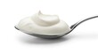 © Poindexter - Close-up of a dollop of fresh, creamy white yogurt or sour cream on a silver spoon, isolated on a clean white background.