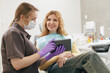 © Parilov - Doctor use tablet computer in stomatology. Young caucasian female at dental checkup with dentist in modern clinic