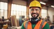 © Farhan - Smiling Builder in High Visibility Gear Standing in Woodworking Workshop