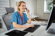 © Jelena - Healthcare professional smiling talking on telephone working at clinic