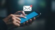 © HASINA - A person holding a smartphone with an email notification icon above the screen