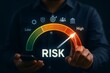 © Nirmal - Person's finger points to a 'high' risk level on a virtual gauge, indicating increased business or financial risk.