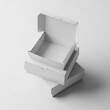 © saiful4613 - Stack of open white cardboard boxes arranged for product packaging mockups isolated on a plain light gray studio background.