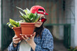 © sav_an_dreas - Gen Z woman holding houseplants urban lifestyle portrait, copy space.