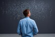 © Andrii Zastrozhnov - Young caucasian male facing chalkboard with confusing scribbles and question marks