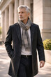 © thodonal - Mature man with gray hair walking in a city setting
