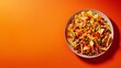 © H Creatives - Delicious plate of nachos loaded with cheese, salsa, and various toppings on a vibrant orange background