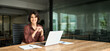 © insta_photos - Smiling Hispanic young woman entrepreneur, happy female executive manager looking at camera sitting at workplace with laptop. Portrait of confident businesswoman leader in her 30s at work desk.