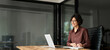 © insta_photos - Female professional executive manager in her 30s using computer, elearning at workplace. Busy happy young Hispanic business woman company owner ceo working in office using laptop writing notes