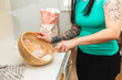 © Diego Martin/Stocksy - Tattooed woman mixing flour
