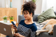 © mahalo studio/Stocksy - woman working and texting from home with pet dog