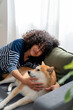© mahalo studio/Stocksy - Woman cuddling with her shiba inu dog