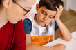 © VICTOR TORRES/Stocksy - Mother helping her frustrated young son with homework