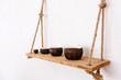 © Tania Cervian/Stocksy - Decorative bowls on wall hanging shelf