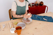 © Tania Cervian/Stocksy - Crop woman squeezing clay at table