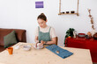 © Tania Cervian/Stocksy - Woman potter working on clay at table in apartment