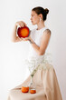 © Tania Cervian/Stocksy - Elegant woman holding pottery near chair with decorative