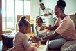 © Marko Geber - Family with kids assembling furniture in new home