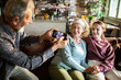 © Geber86 - Grandmother and granddaughter with face masks on sofa at home