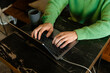 © DZ FILM/Stocksy - Man's hands typing on a laptop
