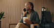 © WesJVR/peopleimages.com - Suitcase, phone call and business black woman in airport lounge for flight tracking, layover update and contact. Communication, boarding schedule and chat with person in vip lobby for travel