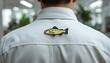 © AI Artworks - A man wearing a white shirt with a fish pin on the back in an office setting
