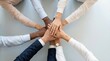 © designerjahanara - Diverse business team stacking hands in unity and cooperation