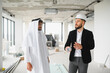 © Serhii - Architect showing construction plans to arab investor in building under construction