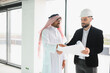 © Serhii - Arab investor and architect discussing plans for new business center